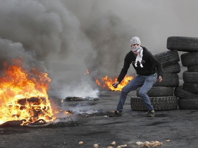A Palestinian protester prepares to hurl stones at Israeli troops during clashes near the Jewish settlement of Bet El, near the West Bank city of Ramallah October 27, 2015. REUTERS/Mohamad Torokman
