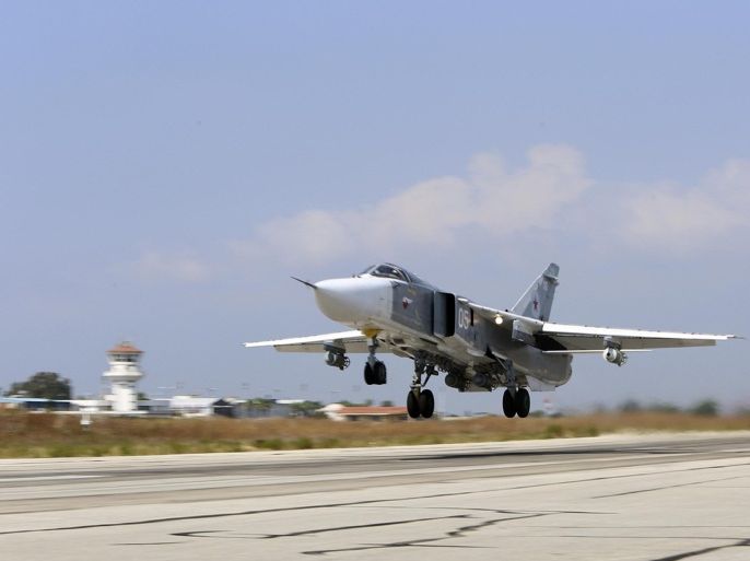 In this photo taken on Saturday, Oct. 3, 2015, Russian SU-24M jet fighter armed with laser guided bombs takes off from a runaway at Hmeimim airbase in Syria. Russia has insisted that the airstrikes that began Wednesday are targeting the Islamic State group and al-Qaida's Syrian affiliates, but at least some of the strikes appear to have hit Western-backed rebel factions. (AP Photo/Alexander Kots, Komsomolskaya Pravda, Photo via AP)
