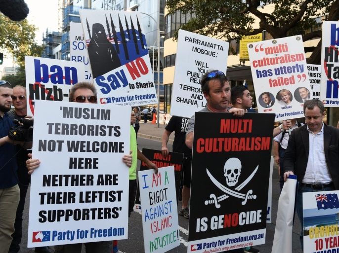 Anti-islamic protesters hold banners as they stand in front of members of the New South Wales (NSW) Police riot squad outside the Parramatta mosque in Sydney, Australia, 09 October 2015. Anti-Islamic protestors plan to rally and call for the Parramatta mosque to be shut down, following the killing of NSW police accountant Curtis Cheng by a 15-year-old boy, who attended the mosque on 02 October just before killing the 58-year-old accountant. EPA/DEAN LEWINS AUSTRALIA AND NEW ZEALAND OUT