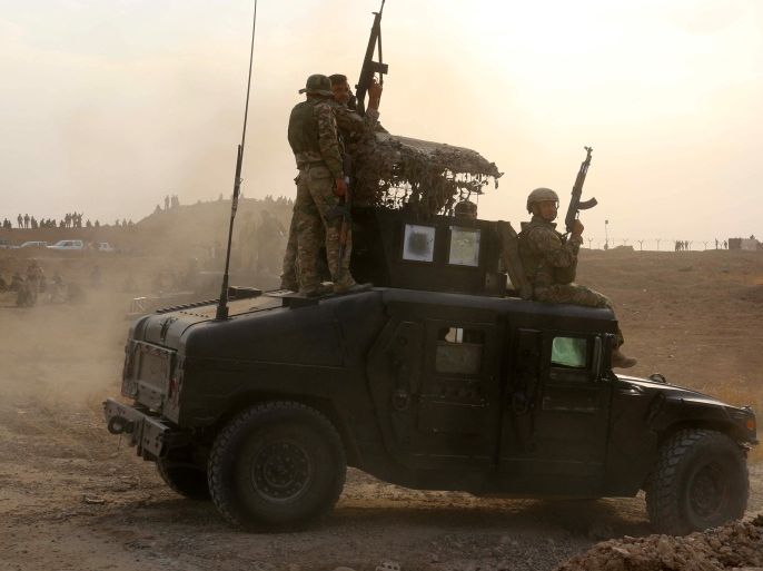 MAI01 - Kirkuk, -, IRAQ : Iraqi Kurdish Peshmerga fighters drive their military vehicle after they reportedly captured several villages from Islamic State (IS) group jihadistst on the outskirts of the northern Iraqi oil capital of Kirkuk on September 30, 2015, during an operation with support from international coalition aircrafts. AFP PHOTO / MARWAN IBRAHIM