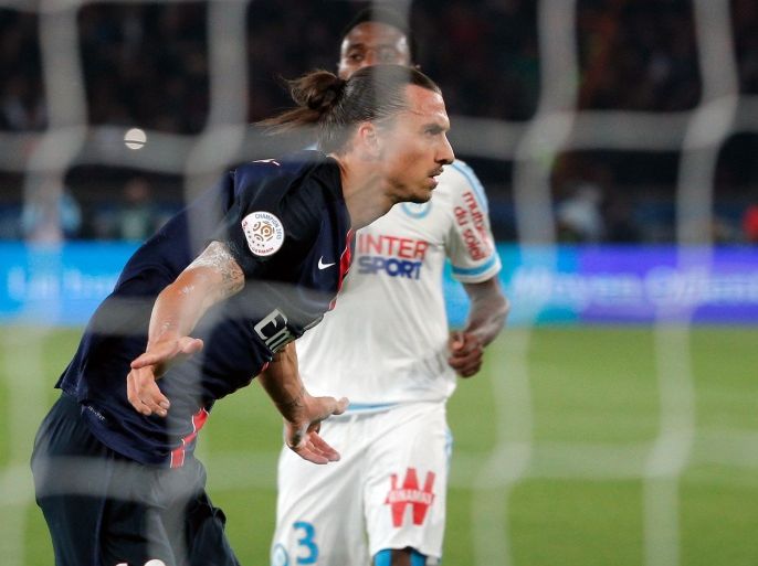 PSG's Zlatan Ibrahimovic celebrates after scoring a goal during his French League One soccer match against Marseille, at the Parc des Princes stadium in Paris, France, Sunday, Oct. 4, 2015. (AP Photo/Thibault Camus)