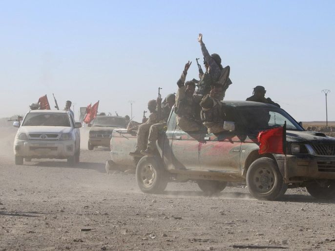 Fighters from the Democratic Forces of Syria move in a convoy in the al-Khatoniyah lake area after they took control of it from Islamic State militants, near al Houl town in Hasaka province, Syria November 14, 2015. A U.S.-backed Syrian rebel alliance on Friday captured the town of al Houl in Hasaka province, which had been held by Islamic State militants, a spokesman for the Kurdish fighters, part of the grouping, said. It was the first significant advance against IS by the Democratic Forces of Syria, which was formed last month. REUTERS/Rodi Said