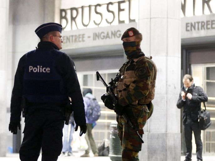 Belgium police officers talk to each other in front of the central station in downtown Brussels, Belgium, Monday, Nov. 23, 2015. The Belgian capital Brussels has entered its third day of lockdown, with schools and underground transport shut and more than 1,000 security personnel deployed across the country. (AP Photo/Michael Probst)