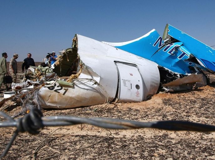 A handout picture provided by the Russian Emergency Ministry press service on 02 November 2015 shows Russian Emergency Situations Minister Vladimir Puchkov (4-L) and unidentified officials near a piece of wreckage of Russian MetroJet Airbus A321 at the site of the crash in Sinai, Egypt, 01 November 2015. The A321 plane of Metrojet en route from Sharm-el-Sheikh, to St. Petersburg crashed in the Sinai, Egypt on 31 October 2015, killing all 224 people on board. EPA/MAXIM GRIGORIEV / RUSSIAN EMERGENCY MINISTRY / HANDOUT HANDOUT EDITORIAL USE ONLY/NO SALES