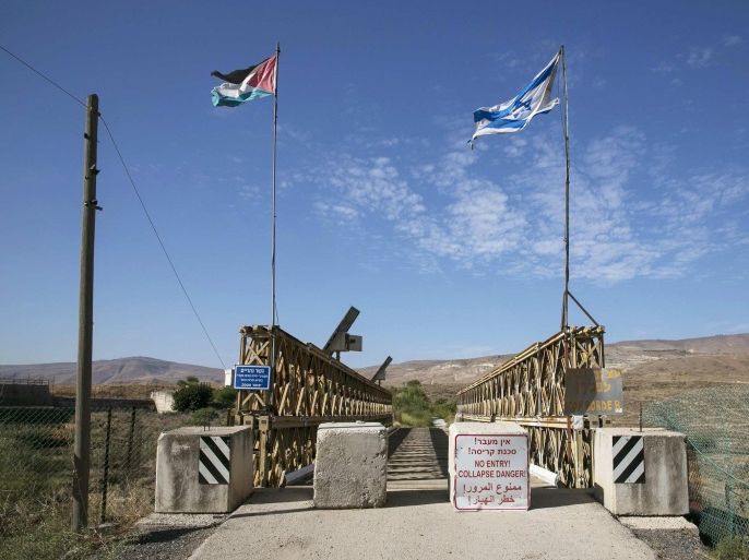 National Jordanian and Israeli flags are seen on the Naharayim bridge on the border between Israel and Jordan north-eastern Israel October 22, 2014. With attacks by Hezbollah from Lebanon, the threat from Islamic State and the Nusra Front in Syria and growing unrest in Egypt's Sinai, the north and south of Israel?s borders are on edge. By comparison, the eastern frontier with Jordan looks like an oasis of calm. Yet the Hashemite kingdom, wedged between Iraq, Syria and Saudi Arabia as well as Israel and the Israeli-occupied West Bank, is tackling an array of destabilising problems that its allies - in particular Israel - are watching warily. To match Insight MIDEAST-ISRAEL/JORDAN REUTERS/Baz Ratner (ISRAEL - Tags: POLITICS CIVIL UNREST)