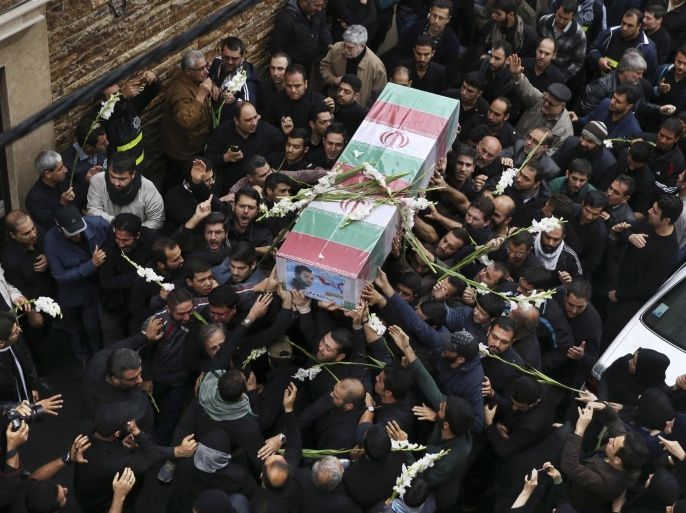 Iranian mourners carry the flag draped coffin of Abdollah Bagheri Niaraki, a onetime bodyguard of former President Mahmoud Ahmadinejad who was killed while fighting in Aleppo in Syria, during his funeral service in front of his home in downtown Tehran, Iran, Thursday, Oct. 29, 2015. Iran's semi-official Fars news agency reported last Friday that Niaraki was killed while fighting alongside Syrian government forces against "terrorists" in the northern city of Aleppo. Iran is a longtime ally of Syrian President Bashar Assad and has provided crucial economic and military backing throughout the uprising and subsequent civil war. Iran says it has sent military advisers to Syria but no combat troops. (AP Photo/Vahid Salemi)