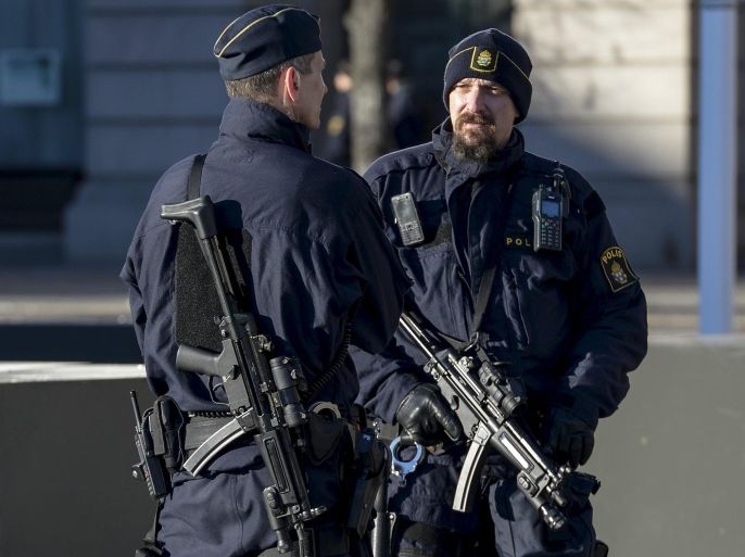 Armed police provide security during a memorial event to honour the victims of the Paris attacks, at the Gustaf Adolfs square in central Stockholm, Sweden, November 21, 2015. REUTERS/Janerik Henriksson/TT News Agency ATTENTION EDITORS - THIS IMAGE HAS BEEN SUPPLIED BY A THIRD PARTY. FOR EDITORIAL USE ONLY. NOT FOR SALE FOR MARKETING OR ADVERTISING CAMPAIGNS. SWEDEN OUT. NO COMMERCIAL OR EDITORIAL SALES IN SWEDEN. NO COMMERCIAL SALES. THIS PICTURE IS DISTRIBUTED EXACTLY AS RECEIVED BY REUTERS, AS A SERVICE TO CLIENTS.