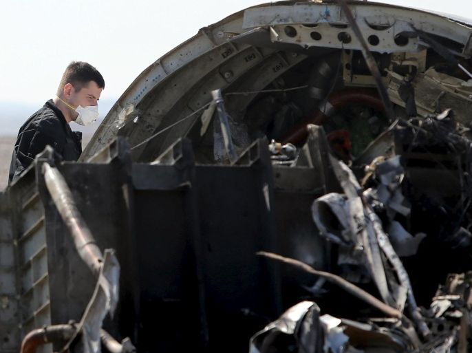 A military investigator from Russia stands near the debris of a Russian airliner at its crash site at the Hassana area in Arish city, north Egypt, November 1, 2015. Russia has grounded Airbus A321 jets flown by the Kogalymavia airline, Interfax news agency reported on Sunday, after one of its fleet crashed in Egypt's Sinai Peninsula, killing all 224 people on board. REUTERS/Mohamed Abd El Ghany