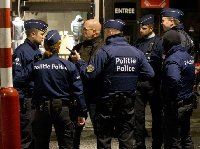 Police stand near a barricade during an operation in the center of Brussels on Sunday, Nov. 22, 2015. Western leaders stepped up the rhetoric against the Islamic State group on Sunday as residents of the Belgian capital awoke to largely empty streets and the city entered its second day under the highest threat level. With a menace of Paris-style attacks against Brussels and a missing suspect in the deadly Nov. 13 attacks in France last spotted crossing into Belgium, the city kept subways and underground trams closed for a second day. (AP Photo/Virginia Mayo)