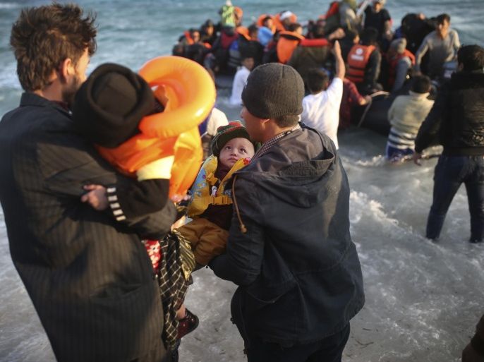 Refugees and migrants abort their effort on a dingy as they set out, trying to travel from the Turkish coast to the Greek island of Chios, near Cesme, Turkey, Saturday, Oct. 31, 2015. Authorities in Greece say 21 people have died in other islands after two boats carrying migrants and refugees from Turkey to Greece sank overnight, in the latest deadly incidents in the eastern Aegean Sea. (AP Photo/Emre Tazegul)