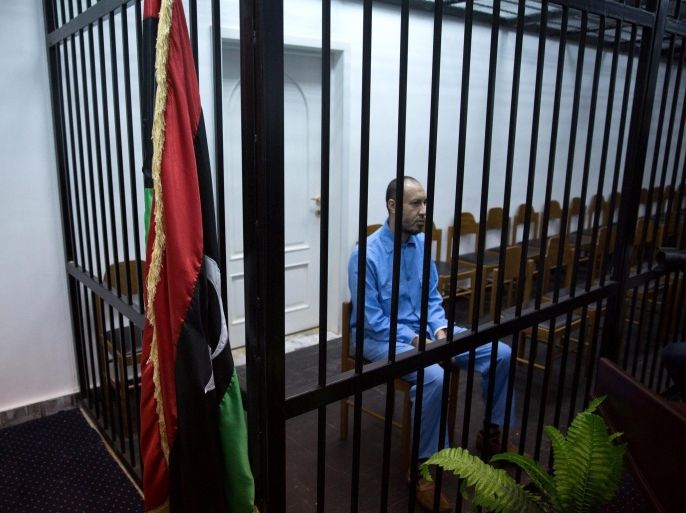 Saadi Gaddafi, son of former Libyan leader Muammar Gaddafi, sits behind bars during a trial session at a courtroom in Tripoli, Libya, 01 November 2015. Saadi Gaddafi is facing charges of murdering a soccer player in 2005. He fled the country after the fall of his father's regime and was extradited from Niger to Libya in March 2014.