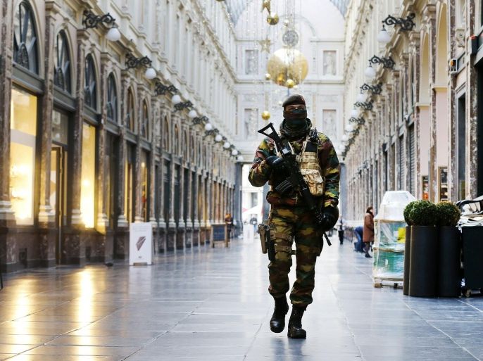 A Belgium army soldier walks through the Galeries Royal Saint-Hubert, or the Royal Saint-Hubert Galleries in Brussels, Belgium, Thursday, Nov. 26, 2015. Brussels is keeping its terror alert on highest level.(AP Photo/Michael Probst)
