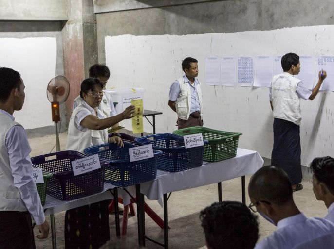 Votes are counted in an unfinished building being used as a polling station in Yangon, Myanmar, Sunday, Nov. 8, 2015. With tremendous excitement and hope, millions of citizens voted Sunday in Myanmar's historic general election that will test whether the military's long-standing grip on power can be loosened, with opposition leader Aung San Suu Kyi's party expected to secure an easy victory. (AP Photo/Amanda Mustard)