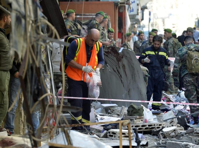 Members of the Lebanese police forces and Hezbollah inspect the site of a twin suicide attack in the Bourj al-Barajneh suburb of Beirut, Lebanon, 13 November 2015. According to local sources at least 43 civilians were killed and over 235 wounded when two suicide attackers blew themselves up 12 November near a busy market outside the al-Imam al-Hussein mosque on al-Husseiniya street in the suburb with a large Hezbollah presence. The group calling themselves the Islamic State (IS) has claimed responsibility for the attack, after which a day of mourning was decalred in Lebanon for 13 November.