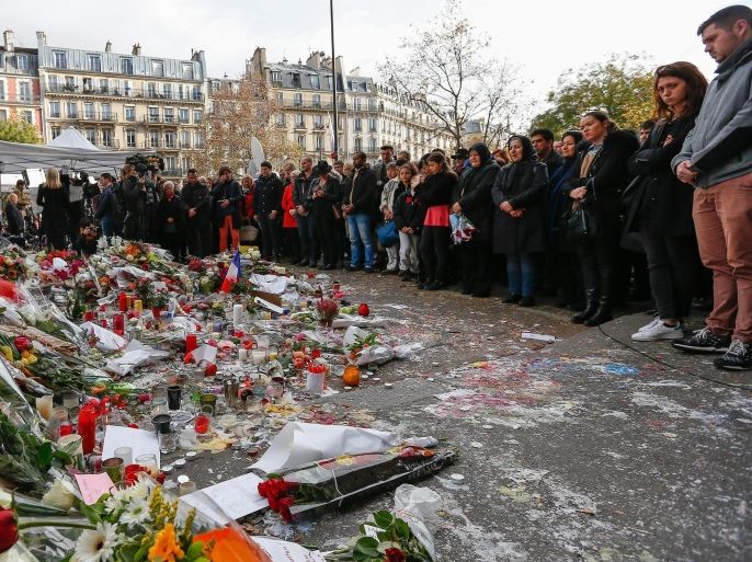 Thousands of people observe a minute of silence near the Bataclan concert venue in Paris, France, 16 November 2015. More than 130 people have been killed in a series of attacks in Paris on 13 November, according to French officials. Eight assailants were killed, seven when they detonated their explosive belts, and one when he was shot by officers, police said. French President Francois Hollande says that the attacks in Paris were an 'act of war' carried out by the Islamic State extremist group.