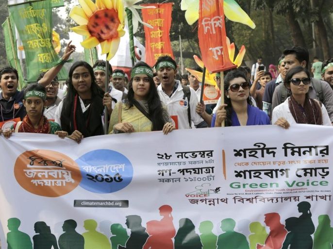 Participants carry banners as they join social and environmental activists, officials from different NGOs, pupils and students from schools, collleges and universities during a march with colorful motifs and the slogan 'Global Climate March for a Safe, Clean Bangladesh' in Dhaka, Bangladesh, 28 November 2015. The National Committee for Saving the Sundarbans, NCSS, Bangladesh Poribesh Andolon, BAPA, Water Keepers Alliance, WKA and AVAAZ Bangladesh had organized the march in solidarity with the 'People's climate march' ahead of the upcoming COP21 Climate Summit in Paris, France.