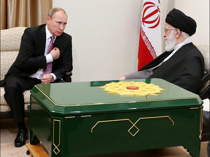 A handout picture made available by the supreme leader official website shows Iranian supreme leader Ayatollah Ali Khamenei (R) receiving a gift from Russian President Vladimir Putin (L), in Tehran, Iran, 23 November 2015. Reports state Putin presented an old Koran manuscript to Khamenei. EPA/LEADER OFFICIAL WEBSITE / HANDOUT