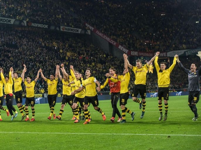Dortmund's players celebrate victory in the German Bundesliga football match between Borussia Dortmund and FC Schalke 04 at the Signal-Iduna-Park in Dortmund, Germany, 8 November 2015.(EMBARGO CONDITIONS - ATTENTION: Due to the accreditation guidelines, the DFL only permits the publication and utilisation of up to 15 pictures per match on the internet and in online media during the match.)