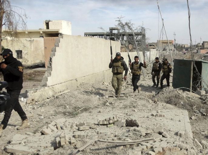 Iraqi Security forces enter the heavy damaged downtown Ramadi, 70 miles (115 kilometers) west of Baghdad, Iraq, Sunday, Dec. 27, 2015. Islamic State fighters are putting up a tough fight in the militant-held city of Ramadi, slowing down the advance of Iraqi forces, Gen. Ismail al-Mahlawi, head of the Anbar military operations, said Sunday. (AP Photo/Osama Sami)