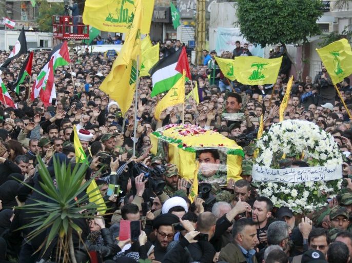 Hezbollah members carry the coffin of Hezbollah militant leader Samir Qantar, as supporters wave Lebanese, Palestinian and Hezbollah flags, during his funeral in Beirut's southern suburbs, Lebanon December 21, 2015. REUTERS/Aziz Taher