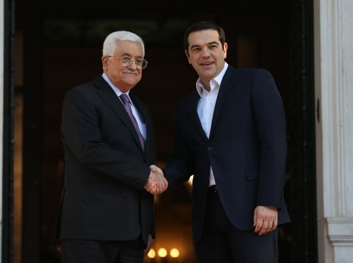 Greek Prime Minister Alexis Tsipras, right, shakes hands with Palestinian President Mahmoud Abbas before their meeting in Athens, on Monday, Dec. 21, 2015. Abbas is in Greece on a two-day official visit. (AP Photo/Petros Giannakouris)