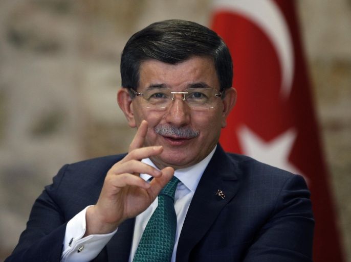 Turkish Prime Minister Ahmet Davutoglu speaks to a group of foreign reporters in Istanbul, Turkey, Wednesday, Dec. 9, 2015. Davutoglu has accused Russia of attempting "ethnic cleansing" through its air campaign in northern Syria. Davutoglu said that Russia’s operations have targeted Turkmen and Sunni communities around the Latakia region and Russia’s action could force “many more millions” of people to flee. (AP Photo/Emrah Gurel)