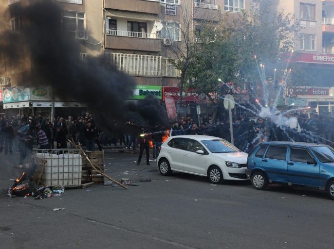 Kurdish protestors clash with Turkish police as they protest against the Turkish government in Diyarbakir, Turkey, 14 December 2015. Residents of the Sur district fled from their houses because of armed clashes between Turkish special forces and PKK militants. According to local media 2 protestors where killed during the protest.
