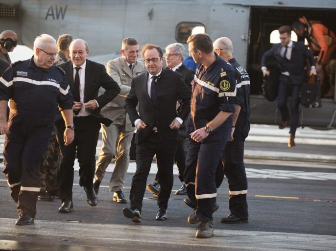 French President Francois Hollande (C) and French Defence Minister Jean-Yves Le Drian (3-L) arrive on French Navy aircraft carrier 'Charles de Gaulle' by helicopter, at sea off the coast of Syria, 04 December 2015. Hollande's impromptu visit underscores France's heightening military aims in the region, as it has scaled up airstrikes against the Islamic State group after the islamists claimed responsibility for a series of terrorist attacks in Paris that left 130 people dead. Thirty-eight fighter jets and military planes are on board the Charles de Gaulle carrier, which moved into the Mediterranean to ramp up airstrikes shortly after the attacks in Paris. The Elysee said 59 operational missions have been carried out from the aircraft carrier. EPA/PHILIPPE DE POULPIQUET/POOL MAXPPP OUT