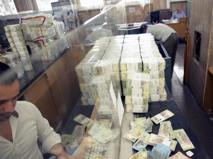 Official at the Central Bank of Syria prepare packs of the new 1000 Syrian pound banknotes during a press conference in Damascus, Syria, 30 June 2015. According to the official Syrian Arab News Agency (SANA), the Central Bank of Syria put into circulation the new 1000 Syrian Pound banknote to improve the paper currency in circulation to help maintain the integrity of paper currency.