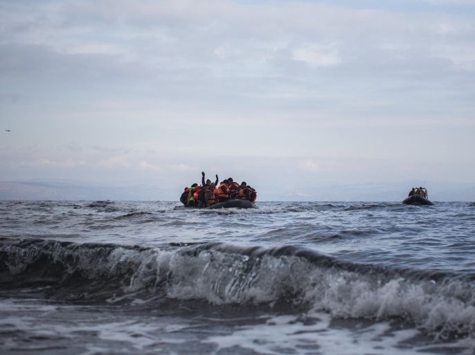 Migrants and refugees onboard a dinghy approach a coast after crossing a part of the Aegean sea from the Turkish coast to the northeastern Greek island of Lesbos, on Wednesday, Dec. 16, 2015. Greek authorities say two people have drowned and 83 others have been rescued after a wooden boat crammed with refugees sank in the Aegean Sea off the eastern Greek island of Lesbos. (AP Photo/Santi Palacios)