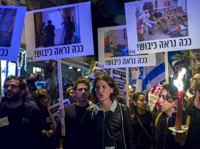 Israelis protesting in a 'Peace Now' march through Tel Aviv, Israel, 19 December 2015 calling on Israelis to choose 'another way' and end the occupation of Palestinian lands. The placards above show forms of occupation under the slogan in Hebrew saying 'This is What the Occupation Looks Like'.