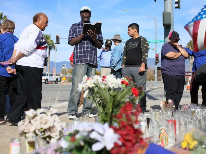 Mourners gather around a makeshift memorial in honor of victims following Wednesday's attack in San Bernardino, California December 5, 2015. Authorities are investigating the shooting as an "act of terrorism", Federal Bureau of Investigation assistant director David Bowdich said at a news conference on Friday. REUTERS/Sandy Huffaker