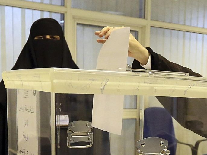 Saudi women vote at a polling center during the municipal elections, in Riyadh, Saudi Arabia, Saturday, Dec. 12, 2015. Women across Saudi Arabia marked a historic milestone on Saturday, both voting and running as candidates in government elections for the first time, but just outside polling stations they waited for male drivers — a reminder of the limitations still firmly in place. (AP Photo/Aya Batrawy)