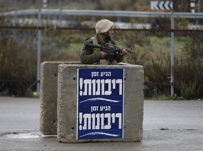 An Israeli soldier secures the scene where Israeli security forces shot dead a Palestinian assailant who tried to stab a man at Gush Etzion junction, near a West Bank settlement on Tuesday, police said, a location that has seen many attacks during two months of violence. December 1, 2015. REUTERS/Baz Ratner