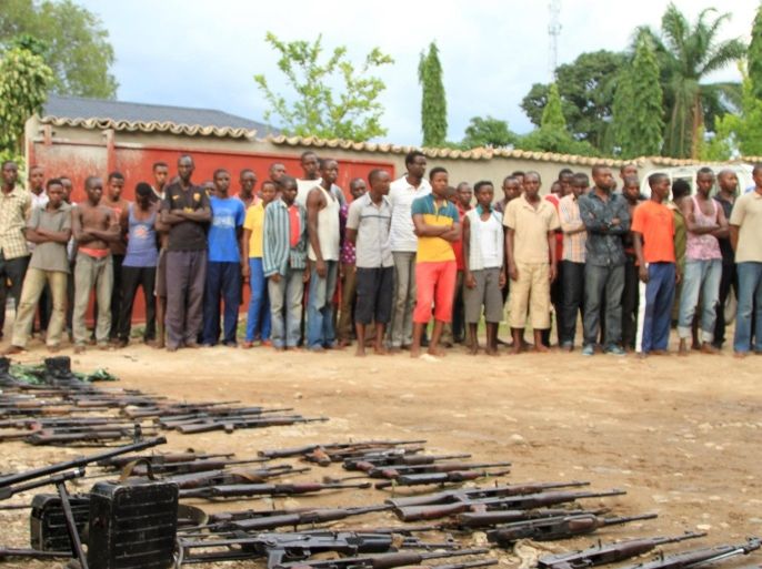 Suspected fighters are paraded before the media by Burundian police near a recovered cache of weapons after clashes in the capital Bujumbura, Burundi December 12, 2015. REUTERS/Jean Pierre Aime Harerimana