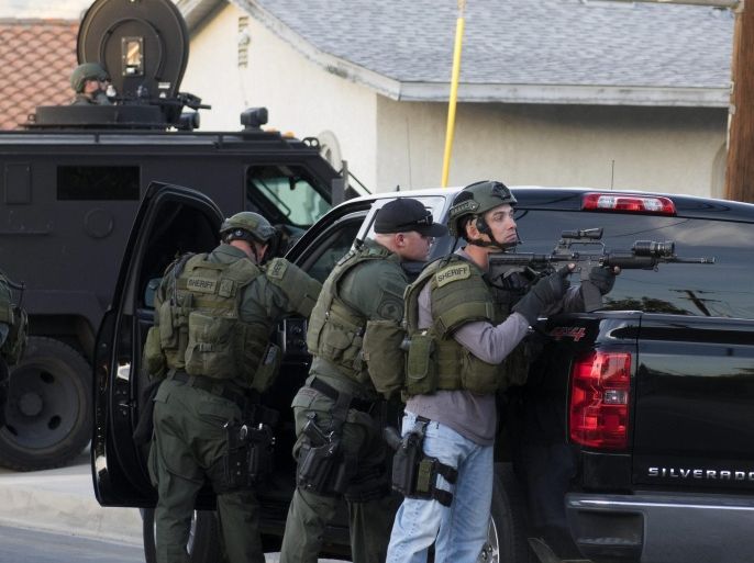Law enforcement officers search for suspects in a neighborhood after a shooting at the Inland Regional Center in San Bernardino, California, USA, 02 December 2015. Police are scouring a residential neighbourhood for a possible third suspect after trading gunfire with occupants of a vehicle linked to an earlier massacre in San Bernardino, police spokeswoman Vicki Cervantes said. A shooting at a government building west of Los Angeles left 'upwards of 14 people' dead and at least 14 wounded, San Bernardino Police Chief Jarrod Burguan says.