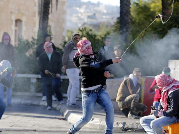 Palestinian protesters fire stones at Israeli soldiers during clashes in the outskirts of the West Bank city of Bethlehem, 08 December 2015. The violence followed the funeral of Palestinian Malik Shaheen who died when Israeli troops met with resistance from the local population, who threw rocks and bottles. The Israelis responded with tear gas grenades and live gunfire that hit Malik Shaheen in the head.