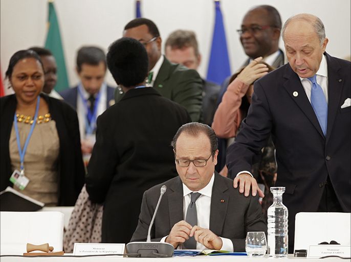 French President Francois Hollande (L) speaks with French Foreign Affairs minister Laurent Fabius prior to "The Climate Challenge and African solutions" event as part of the World Climate Change Conference 2015 (COP21), at Le Bourget on the outskirts of the French capital Paris. World leaders opened an historic summit in the French capital with "the hope of all of humanity" laid on their shoulders as they sought a deal to tame calamitous climate change. AFP PHOTO/POOL/PHILIPPE WOJAZER