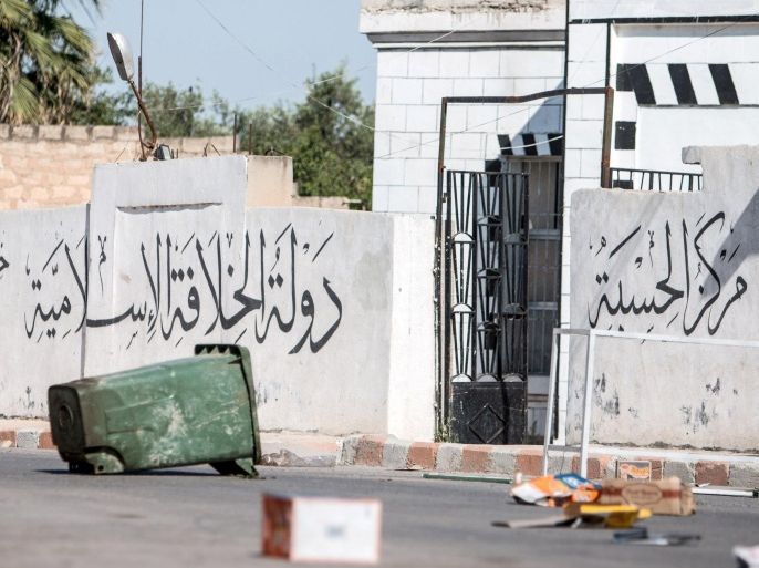 A deserted stronghold that belonged to Islamic State fighters is seen in Tel Abyad town, Raqqa governorate, June 16, 2015. With a string of victories over Islamic State, Syria's Kurds are proving themselves an ever more dependable ally in the U.S.-led fight against the jihadists and building influence that will make them a force in Middle Eastern politics. Aided by U.S.-led air strikes, the Kurdish-led YPG militia may have dealt Islamic State its worst defeat to date in Syria by seizing the town of Tel Abyad at the Turkish border, cutting a supply route to the jihadists' de facto capital of Raqqa city. The text on the wall reads: "Islamic Caliphate State, accountability center, the succession to the Platform of prophecy." REUTERS/Rodi Said