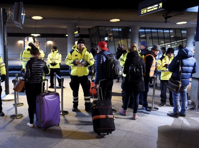 Security staff check IDs at Kastrups train station outside Copenhagen, Denmark, 04 January 2015. Identity checks went into effect for travellers from Denmark to Sweden as part of measures to reduce the flow of migrants into Sweden. Passengers boarding trains, ferries or buses bound for Sweden have to show a passport or other form of valid ID card to be allowed onboard under the new rules. Transport companies are responsible for conducting the checks. Danish train operator DSB said it has set up 34 check points at the Kastrup train station that serves Copenhagen Airport, and is the last train stop before the Swedish border. EPA/BJORN LINDGREN SWEDEN OUT