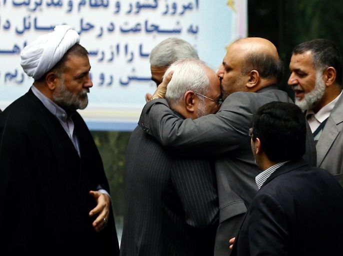 Parliament members congratulate Iranian Foreign Minister Mohammad Javad Zarif (2-L) after some international sanctions against Iran were lifted, during a parliamentary session on the Iranian budget for the coming year, in Tehran, Iran, 17 January 2016. EU and US sanctions targeting Iran's economy and financial sectors are being lifted as the long-sought nuclear deal with the Islamic republic comes into effect, EU chief diplomat Federica Mogherini said late 16 January 2016, speaking on behalf of six world powers.
