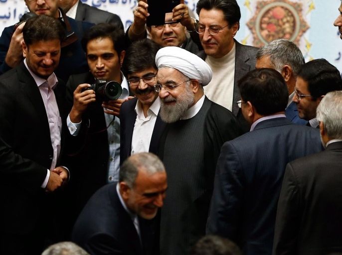 Parliament members congratulate Iranian President Hassan Rowhani (C) after some international sanctions against Iran were lifted, during a parliamentary session on the Iranian budget for the coming year, in Tehran, Iran, 17 January 2016. EU and US sanctions targeting Iran's economy and financial sectors are being lifted as the long-sought nuclear deal with the Islamic republic comes into effect, EU chief diplomat Federica Mogherini said late 16 January 2016, speaking on behalf of six world powers.