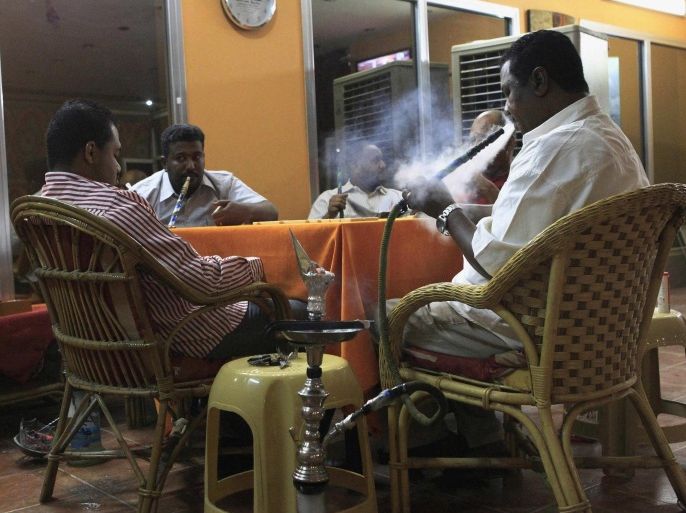 Customers play domino as they smoke waterpipes at a Shisha cafe in Khartoum April 28, 2013. REUTERS/Mohamed Nureldin Abdallah