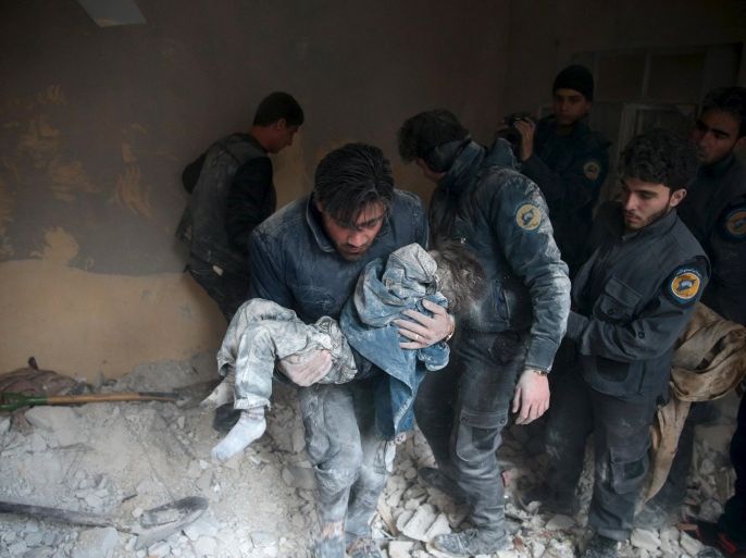 ATTENTION EDITORS - VISUAL COVERAGE OF SCENES OF DEATH AND INJURYA man carries a child that survived from under debris in a site hit by what activists said were airstrikes carried out by the Russian air force in the town of Douma, eastern Ghouta in Damascus, Syria January 10, 2016. REUTERS/Bassam Khabieh