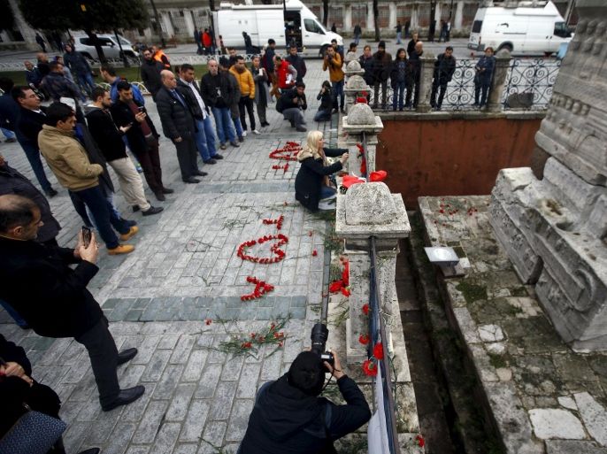 A woman places flowers at the site of Tuesday's suicide bomb attack at Sultanahmet square in Istanbul, Turkey January 13, 2016. REUTERS/Osman Orsal