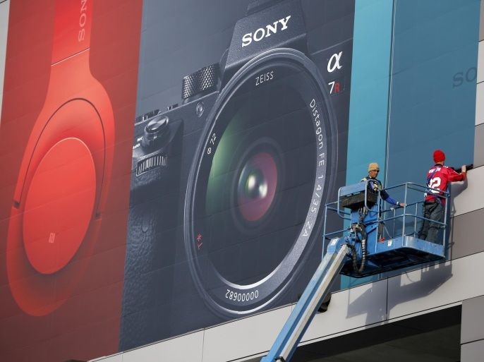 Workers install a sign for Sony products in preparation for the International CES gadget show Sunday, Jan. 3, 2016, in Las Vegas. The show officially kicks off Wednesday, Jan. 6. (AP Photo/John Locher)