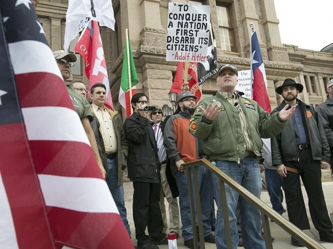 C.J. Grisham, founder of Open Carry Texas, front right, talks to rally participants celebrating Texas' right to Open Carry, Friday, Jan. 1, 2016, on the steps of the Texas state Capitol, in Austin, Texas. After the rally some participates took a short walk down Congress Avenue. (Ralph Barrera /Austin American-Statesman via AP) AUSTIN CHRONICLE OUT, COMMUNITY IMPACT OUT, INTERNET AND TV MUST CREDIT PHOTOGRAPHER AND STATESMAN.COM, MAGS OUT; MANDATORY CREDIT