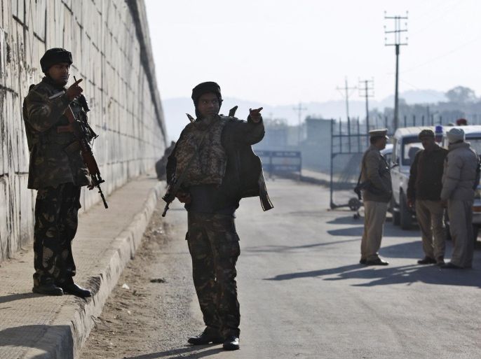 Indian security forces stand outside an Indian air force base in Pathankot, 430 kilometers (267 miles) north of New Delhi, India, Saturday, Jan. 2, 2016. Gunmen attacked the air force base near the border with Pakistan on Saturday morning and exchanged fire with security forces, officials said. (AP Photo/Channi Anand)