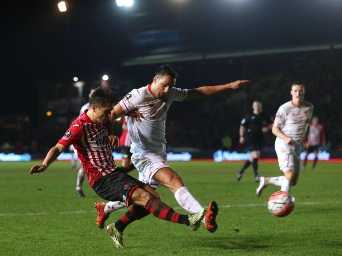 Exeter City's Tom Nichols, left, and Liverpool's Jose Enrique battle for the ball during the English FA Cup third round soccer match at St James Park, Exeter, England, Friday Jan. 8, 2016. (David Davies/PA via AP) UNITED KINGDOM OUT