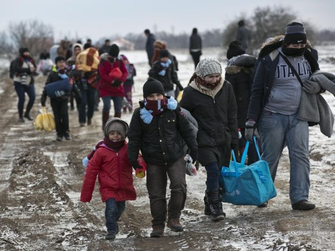 Migrants walk through snow from the Macedonian border into Serbia, near the village of Miratovac, Serbia, on Monday, Jan. 18, 2016. Bracing cold temperatures and snow storms hundreds of migrants continue to arrive daily into Serbia in order to register and continue their journey further north towards Western Europe. (AP Photo/Visar Kryeziu)